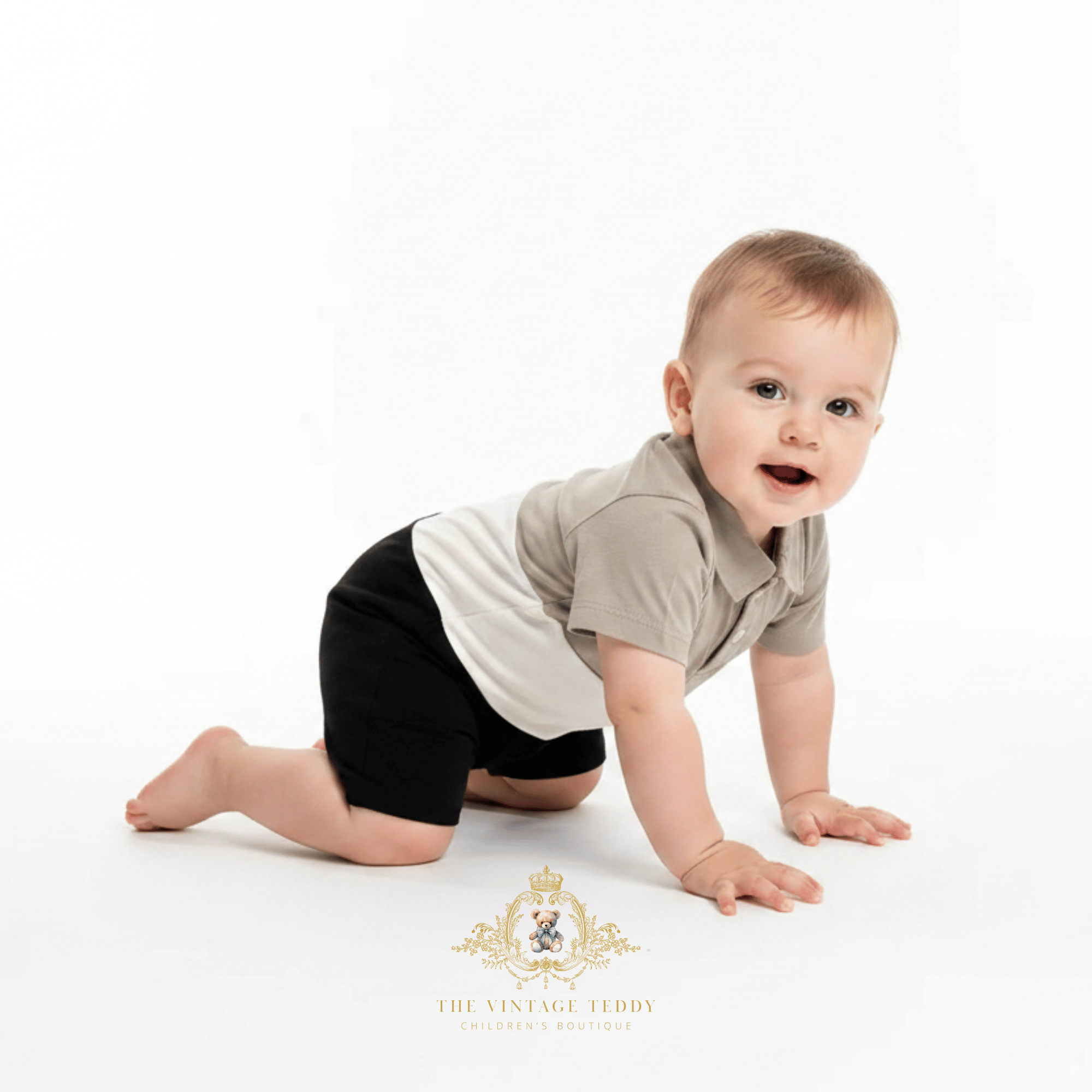 A baby crawling on a white studio floor wearing a short-sleeve polo one-piece bodysuit with a beige and white color-blocked design. The Vintage Teddy Children's Boutique logo is visible at the bottom.