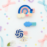 Blue rainbow and lollipop hair clips for girls – flat lay mockup of children's hair accessories from The Vintage Teddy boutique