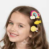 Girl wearing yellow rainbow and lollipop hair clips – children's hair accessories styled on model from The Vintage Teddy boutique