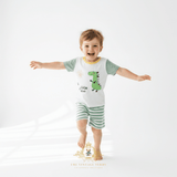 Happy little boy wearing 2-piece matching set for kids, with little dino theme, cute kids clothes for summer