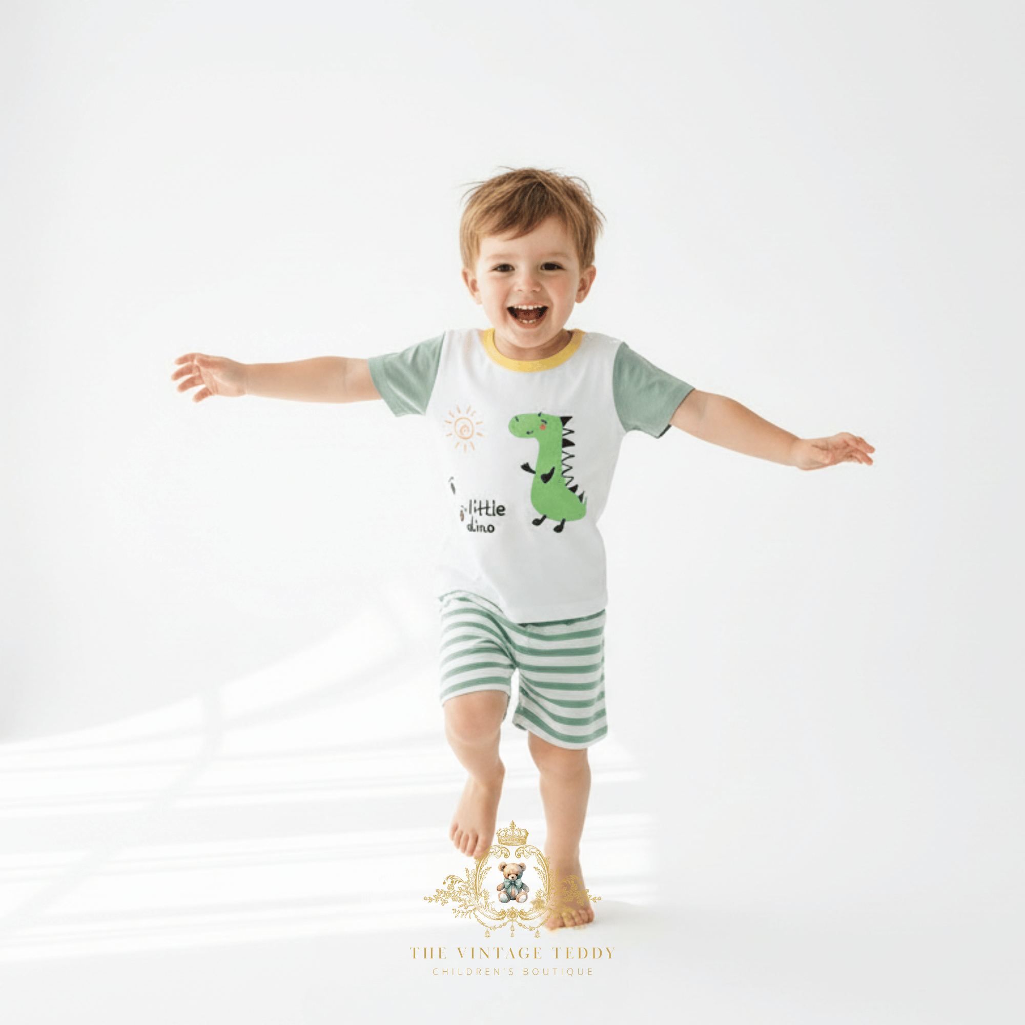 Happy little boy wearing 2-piece matching set for kids, with little dino theme, cute kids clothes for summer