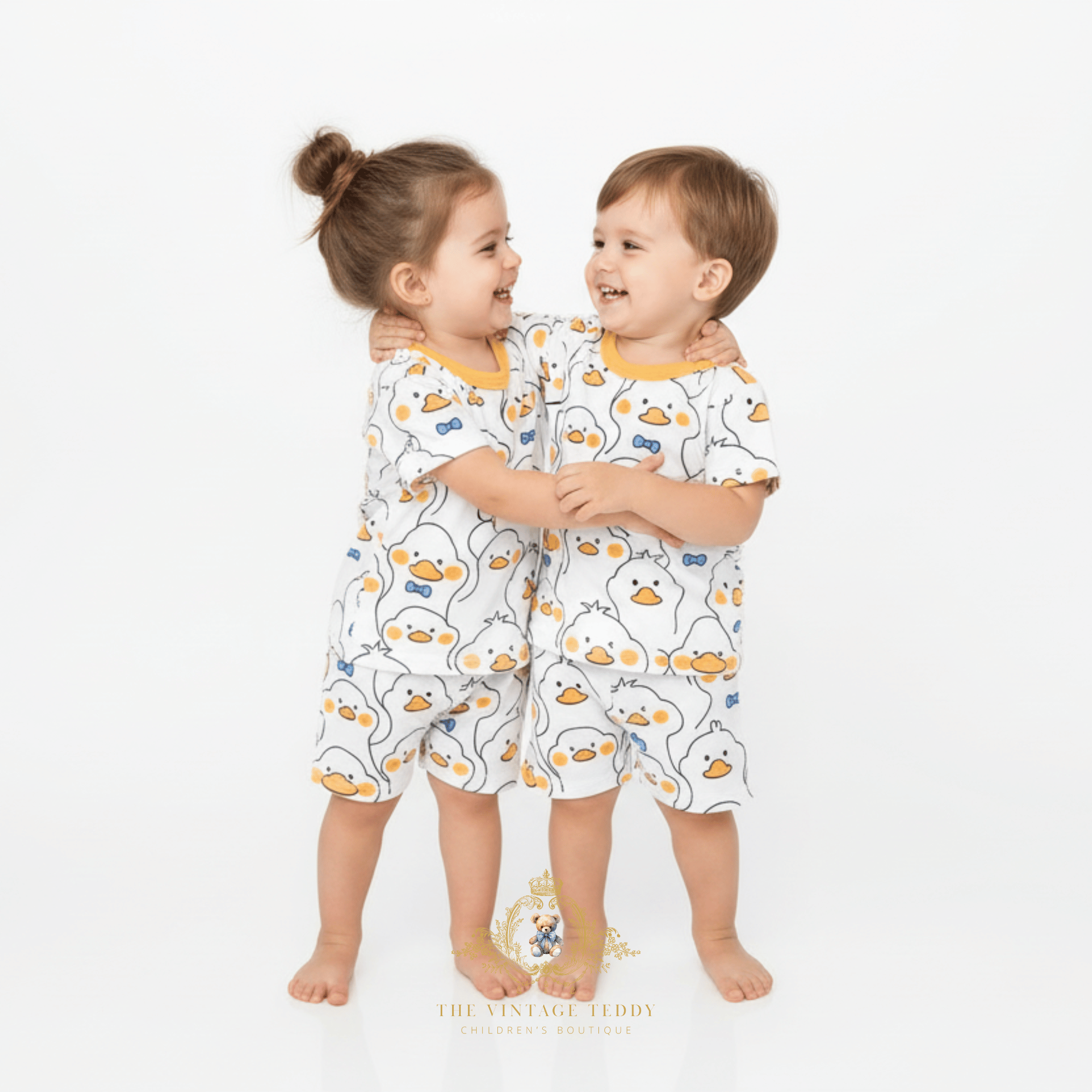 Brother and sister hugging in matching Mr. Duck t-shirt and shorts sets toddler sibling outfits boutique kids clothing