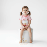 Toddler girl sitting on stool wearing Sweet Bear matching set girls top and shorts outfit for kids