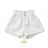Kids white high-waisted denim shorts with an elastic waistband and two silver buttons, shown on a plain white background with The Vintage Teddy's  watermark at the bottom.