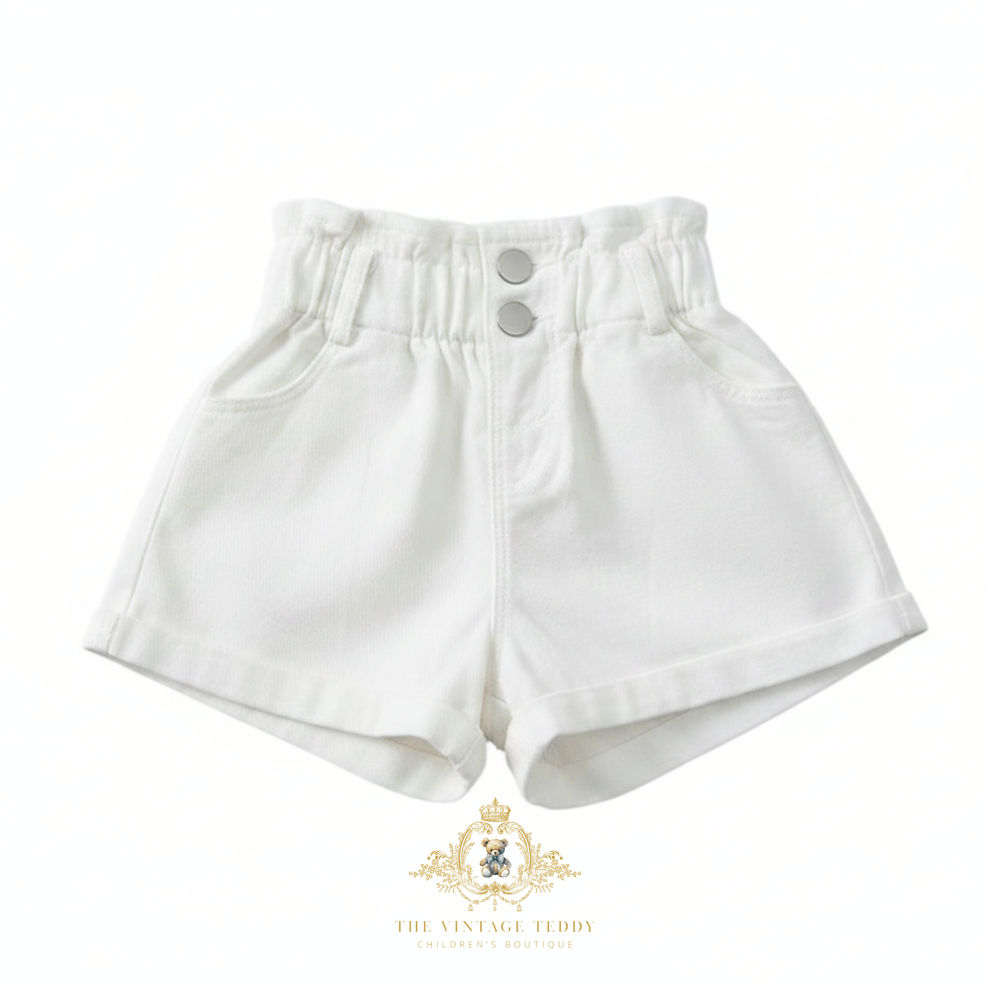 Kids white high-waisted denim shorts with an elastic waistband and two silver buttons, shown on a plain white background with The Vintage Teddy's  watermark at the bottom.