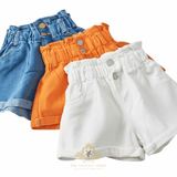 Three pairs of high-waisted kids shorts in blue denim, orange 100% cotton, arranged overlapping on a white background with The Vintage Teddy's logo at the bottom.