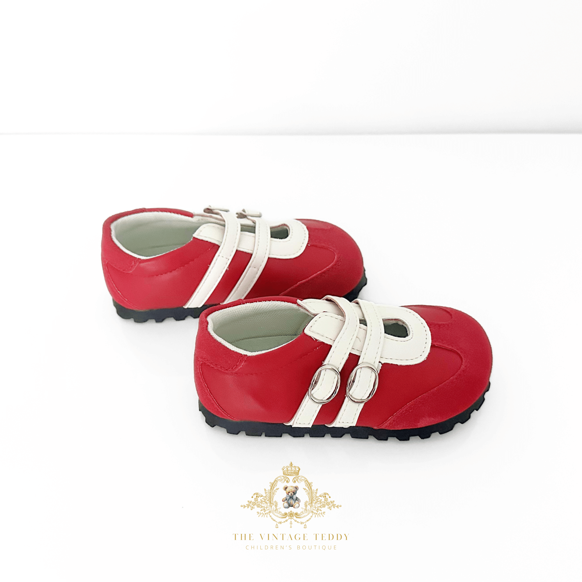 A pair of red children's shoes little girls sneakers with white straps and silver buckle details, displayed on a clean white background with The Vintage Teddy's brand watermark at the bottom.