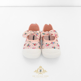 Pretty pair of pink floral baby shoes, kids sneakers with bow and white soles on a light background featured on The Vintage Children's Boutique.