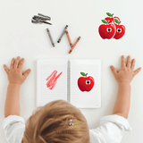 Child's hands reaching towards a notebook with a red apple character stickers for kids, surrounded by crayons and apple sticker and red crayon scribble  on a white background.