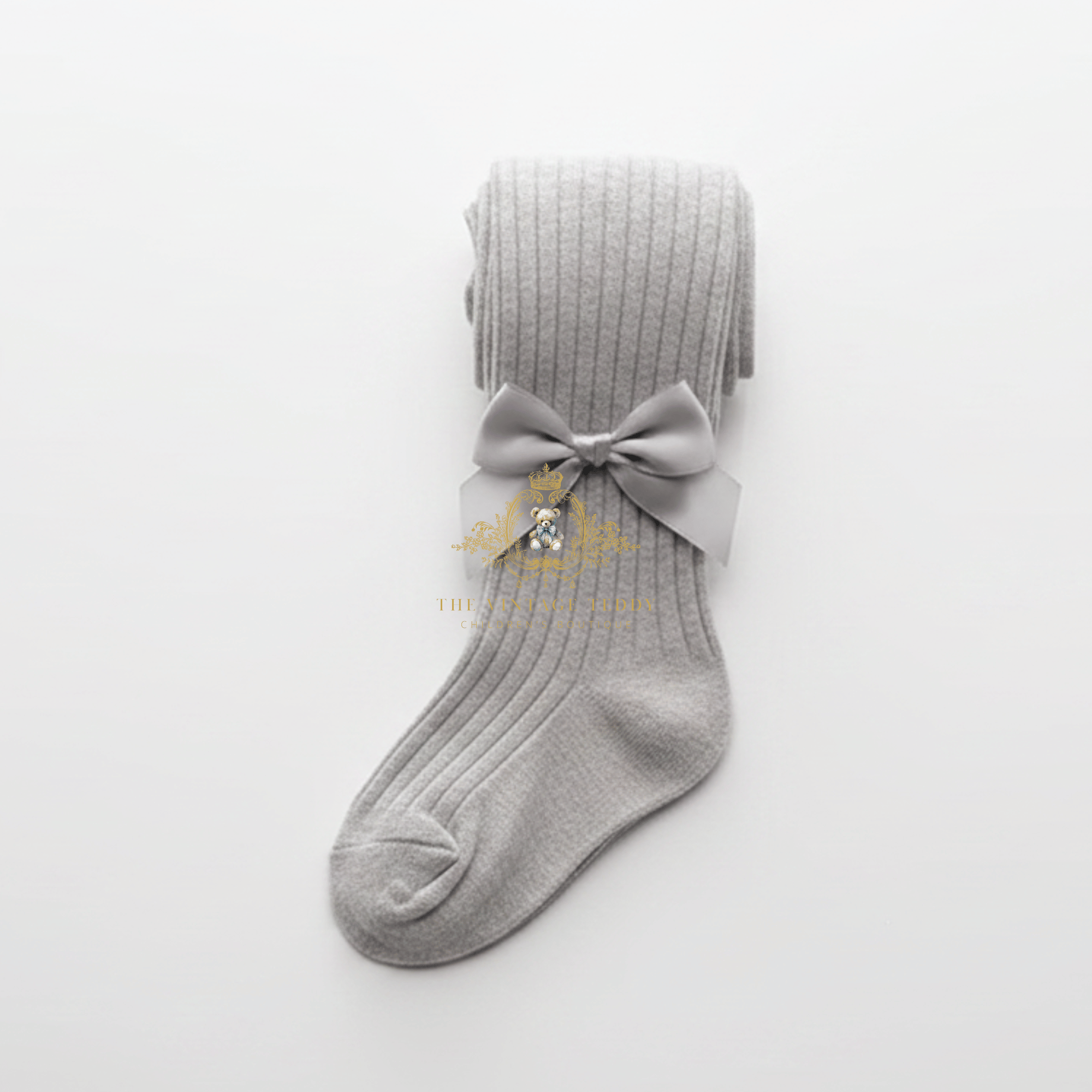 A light gray ribbed knit kids sock with a matching gray satin bow displayed on a clean white background.
