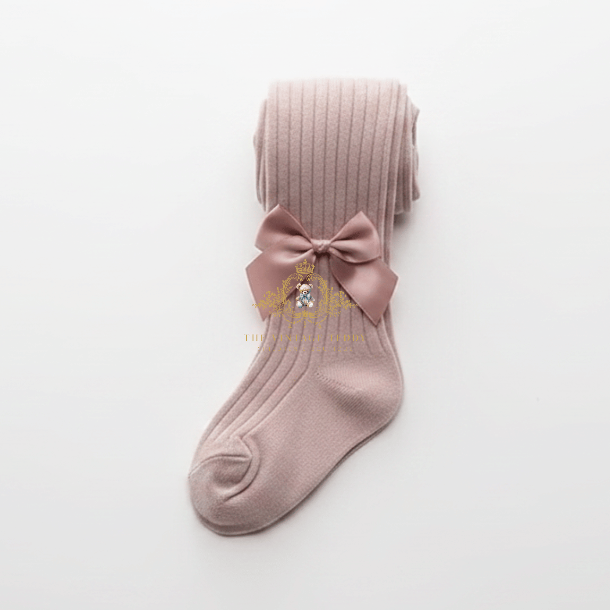 A single ribbed knit kids sock or girls stocking in a dusty mauve-pink color, featuring a matching fabric bow displayed on a clean white background.