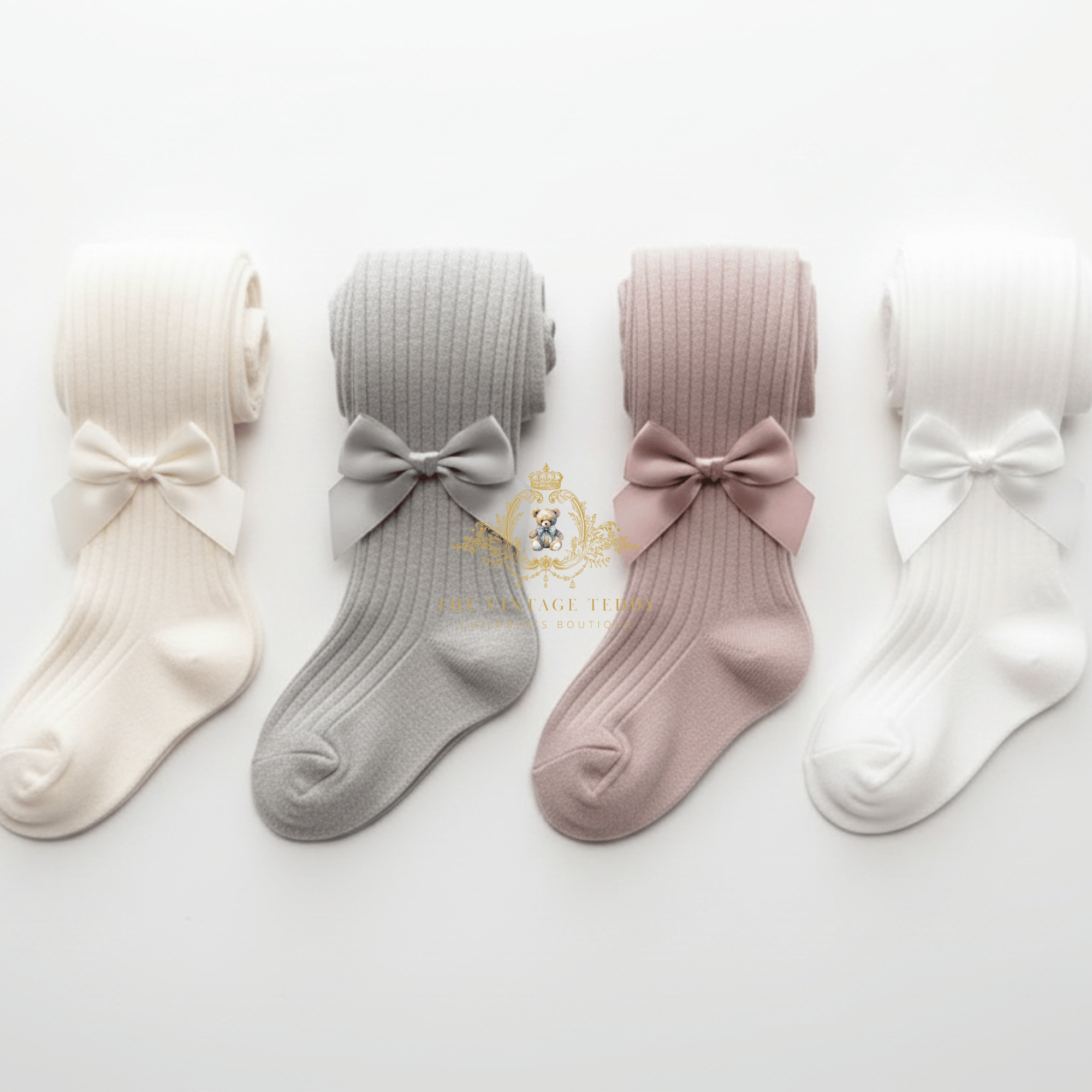Four pairs of ribbed little girls tights with bow details, shown in cream, light gray, dusty pink, and white. A gold watermark logo for 'The Vintage Teddy' is visible in the center.