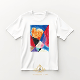 Flat lay of a children's white t-shirt with a custom colorful stain glass watercolor artwork, an abstract heart is in the center, on a light studio background surface. The Vintage Teddy's logo is visible at the bottom of the image.